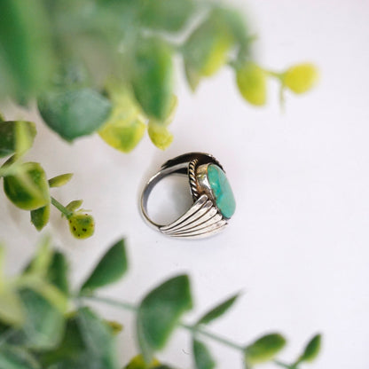 Vintage turquoise and sterling silver ring featuring natural turquoise stone set in wing-shaped silver band, Native American inspired 925 silver jewelry.