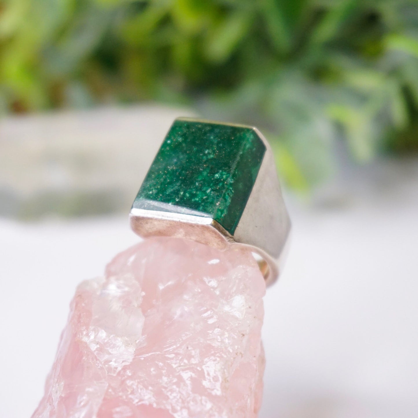 Vintage sterling silver ring with square-shaped green druzy quartz stone against blurred natural background