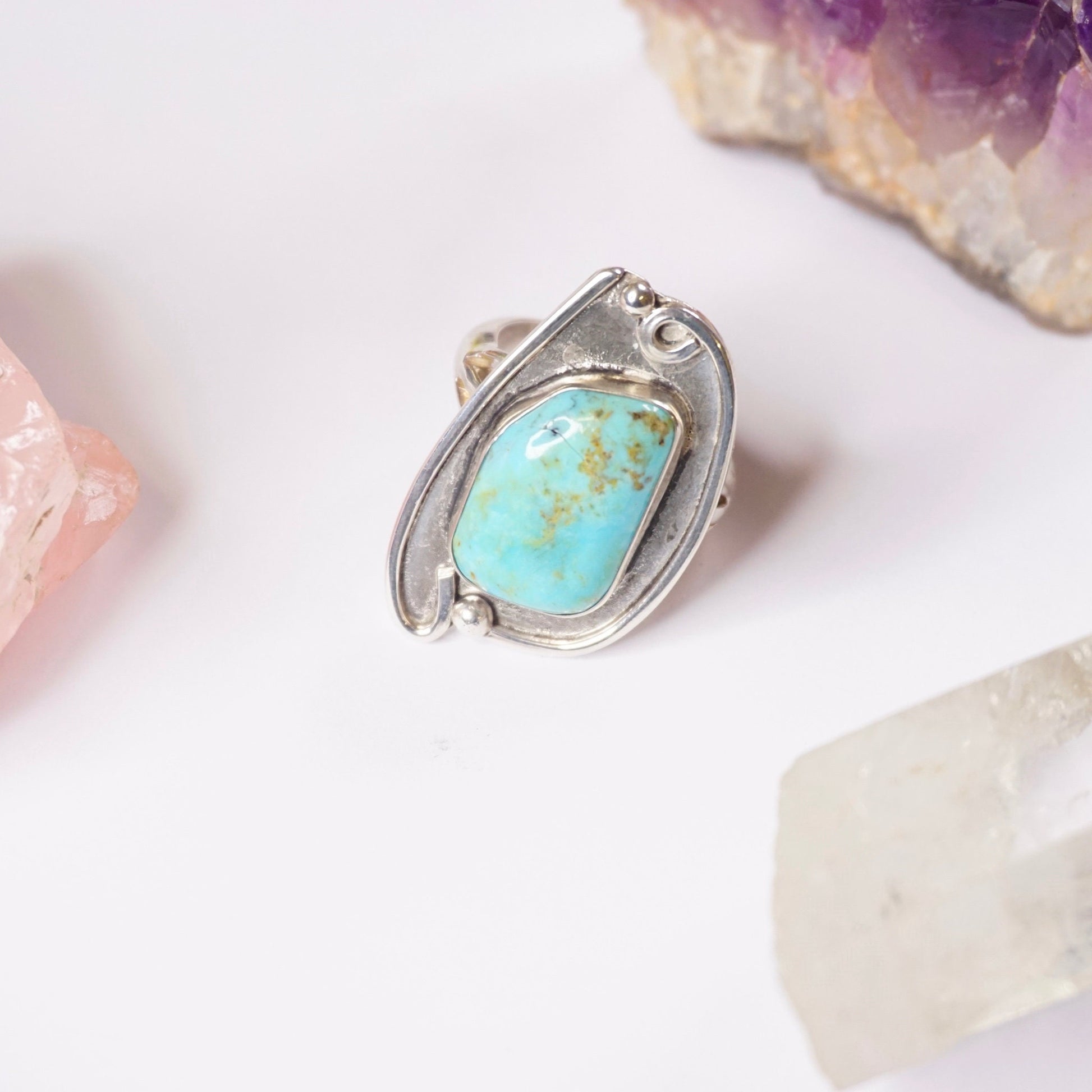 Vintage turquoise sterling silver ring featuring a large natural turquoise stone in an ornate silver setting, exemplifying traditional Native American jewelry design.