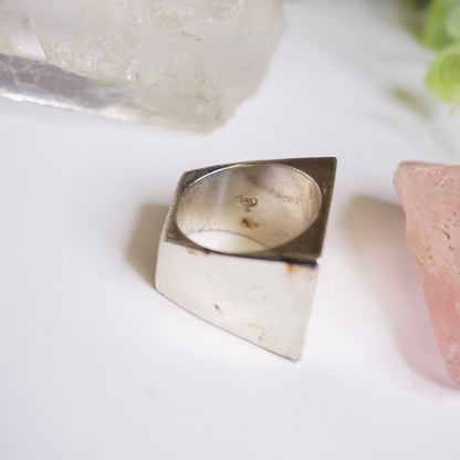 Vintage sterling silver signet ring with thick rectangular face, solid 925 silver men's ring displayed on white background with crystal and stone accents.