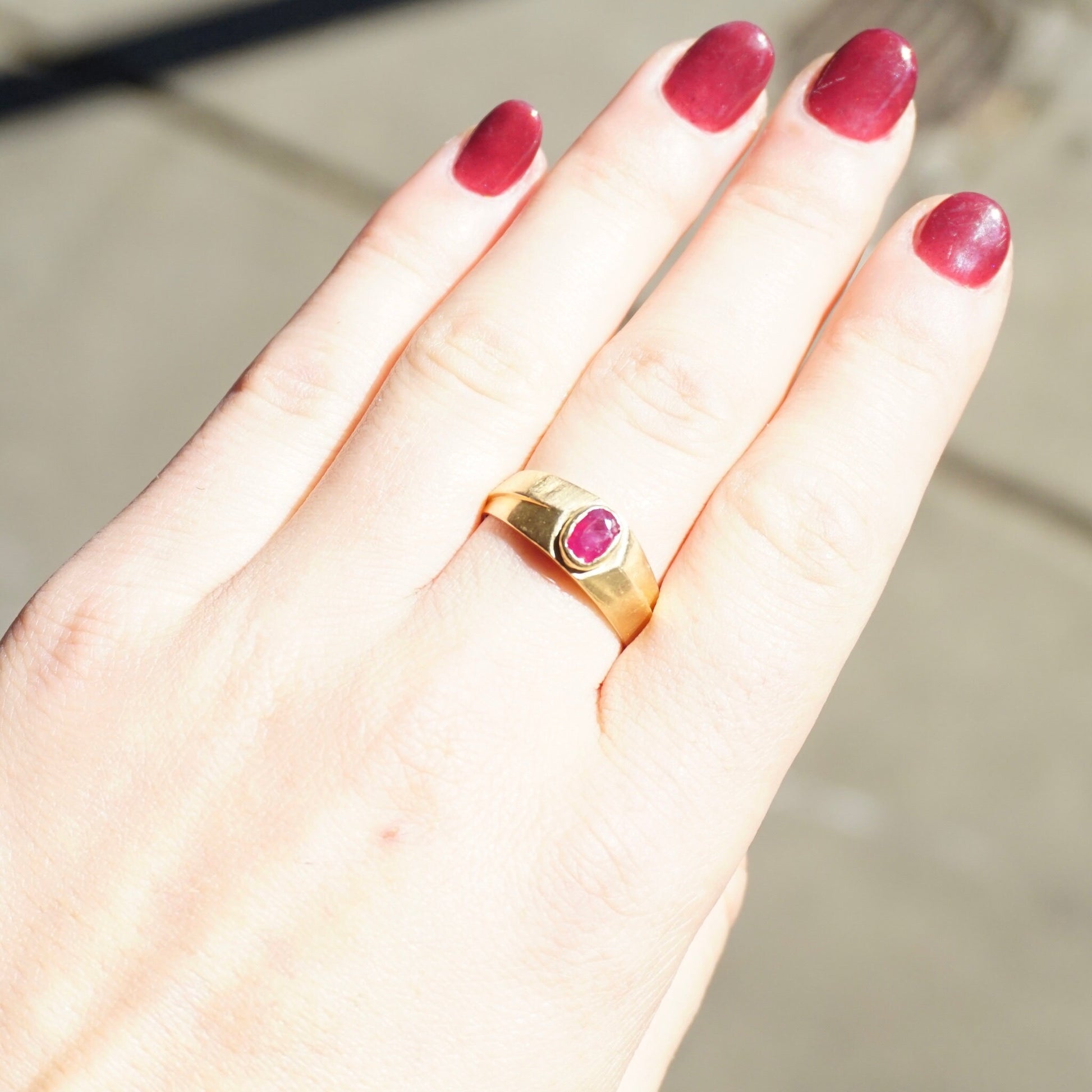 Vintage 10K gold ring with authentic ruby gemstone on a hand, showcasing the small red ruby and the elegant gold band, sized 10 1/4 US and suitable as a unisex ring.