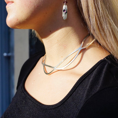 Vintage sterling silver cut out collar necklace from Mexico, featuring a wavy, modern minimalist design. The 925 silver choker is shown worn on a woman's neck against her black top.