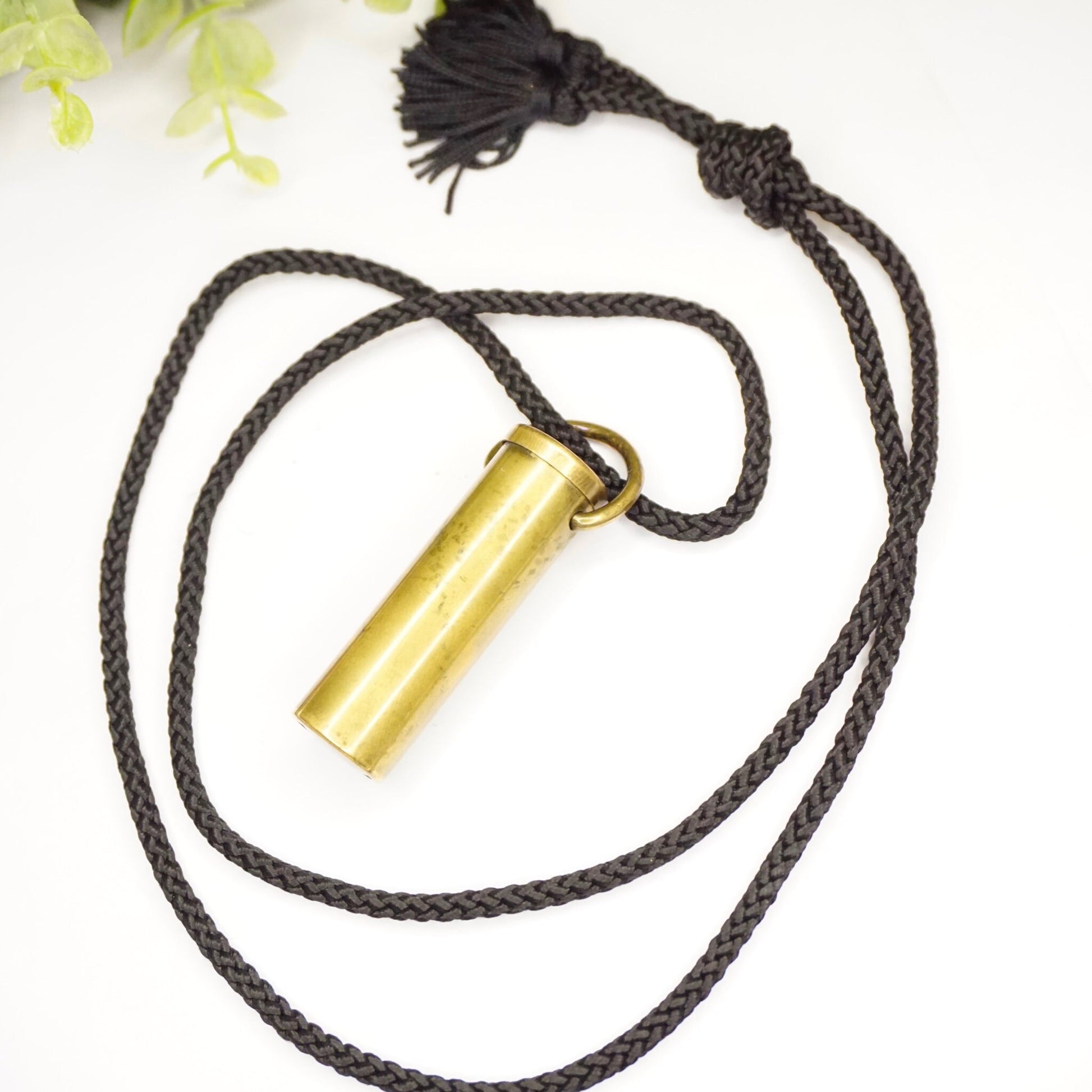 Vintage brass kaleidoscope pendant necklace with black rope cord, made in France. Unique kaleidoscope jewelry design with decorative tassel.