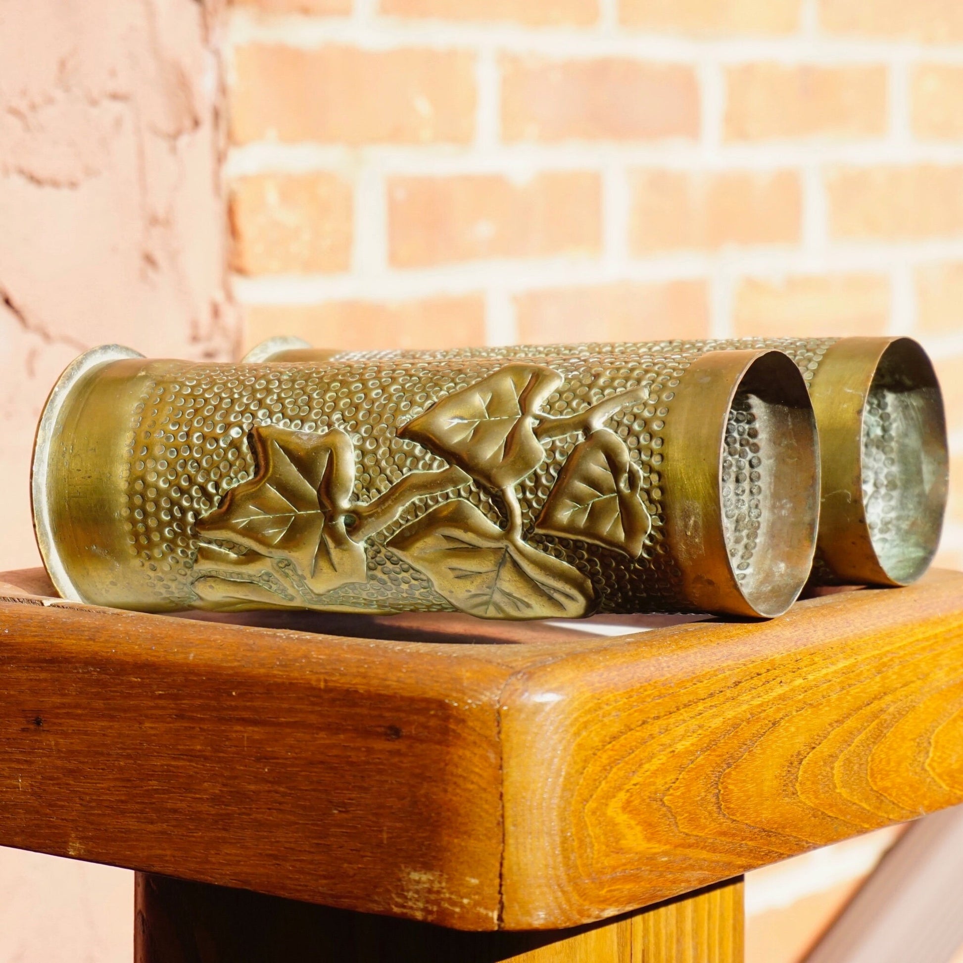 Antique brass shell casing repurposed as brush holder with etched leaf design, World War I trench art from France dated 1917.