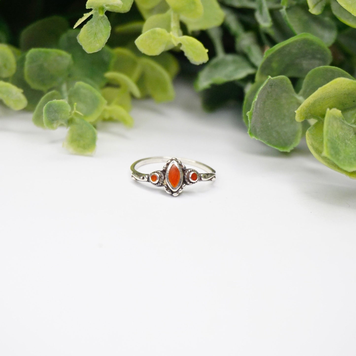 Vintage sterling silver ring with red stone or glass accent, featuring swirl details on a thin band, petite size, 925 silver.