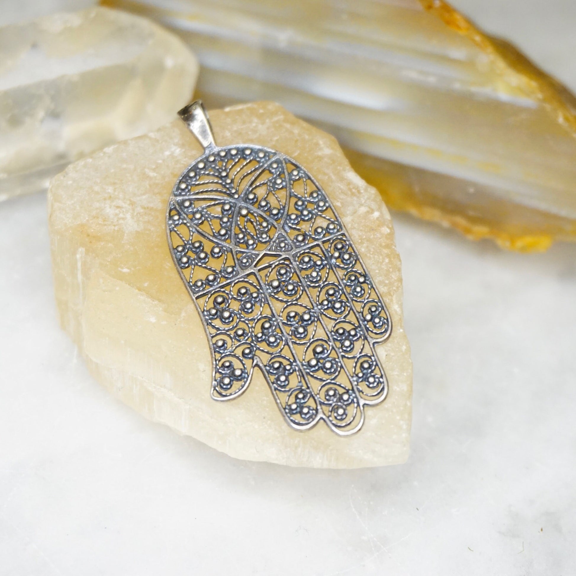 Vintage sterling silver filigree Hamsa hand pendant with intricate detailing, made in Israel. Protective talisman pendant crafted from 925 silver jewelry.