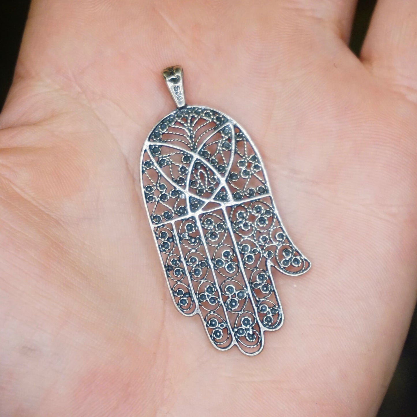 Vintage sterling silver filigree Hamsa hand pendant with intricate swirling patterns and turquoise stones, crafted in Israel as a protective talisman amulet.