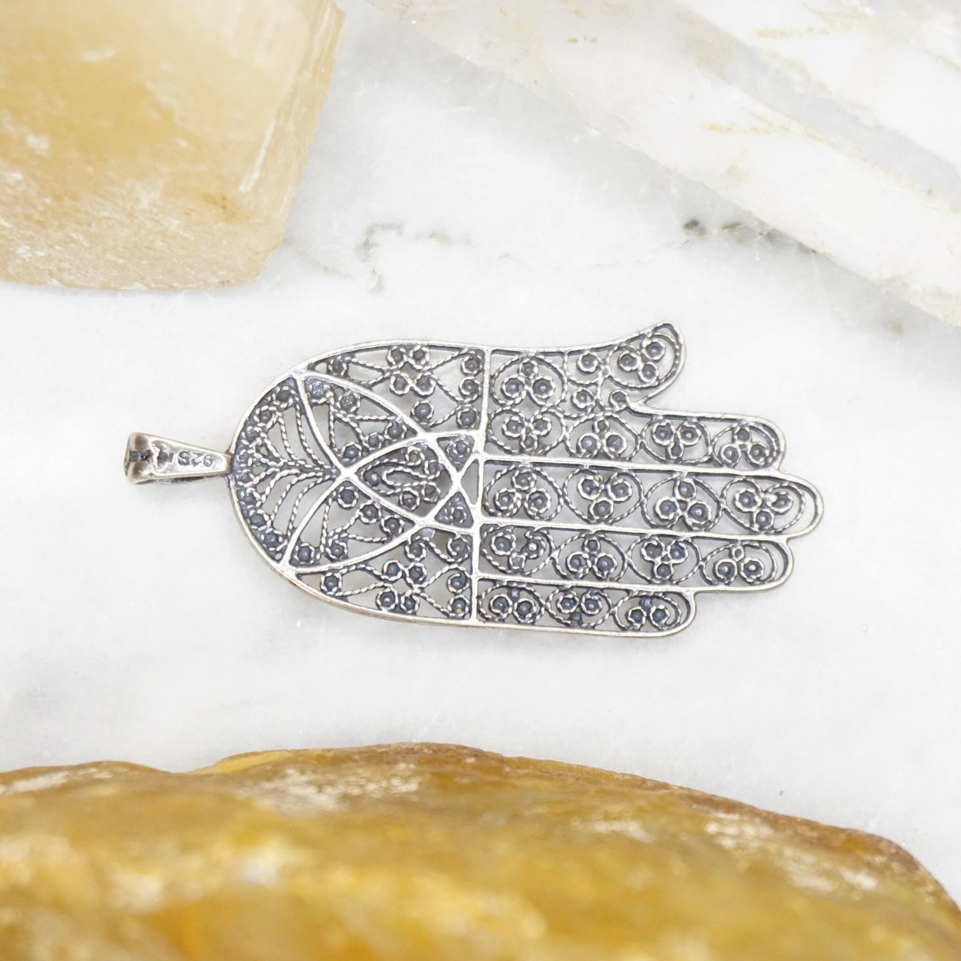 Vintage sterling silver filigree Hamsa hand pendant with intricate detailing, a protective talisman made in Israel from 925 silver jewelry.