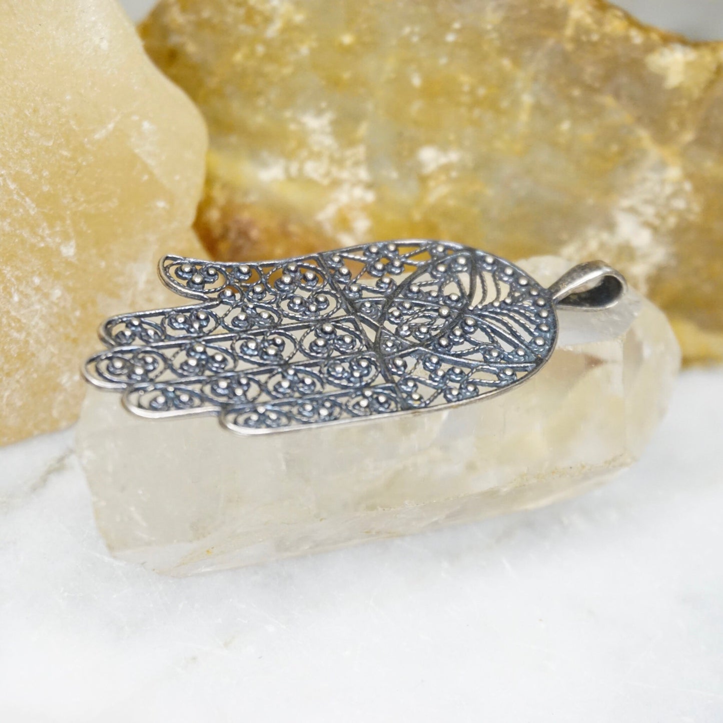 Vintage sterling silver filigree Hamsa hand pendant crafted in intricate detail, a protective talisman made in Israel from 925 silver.