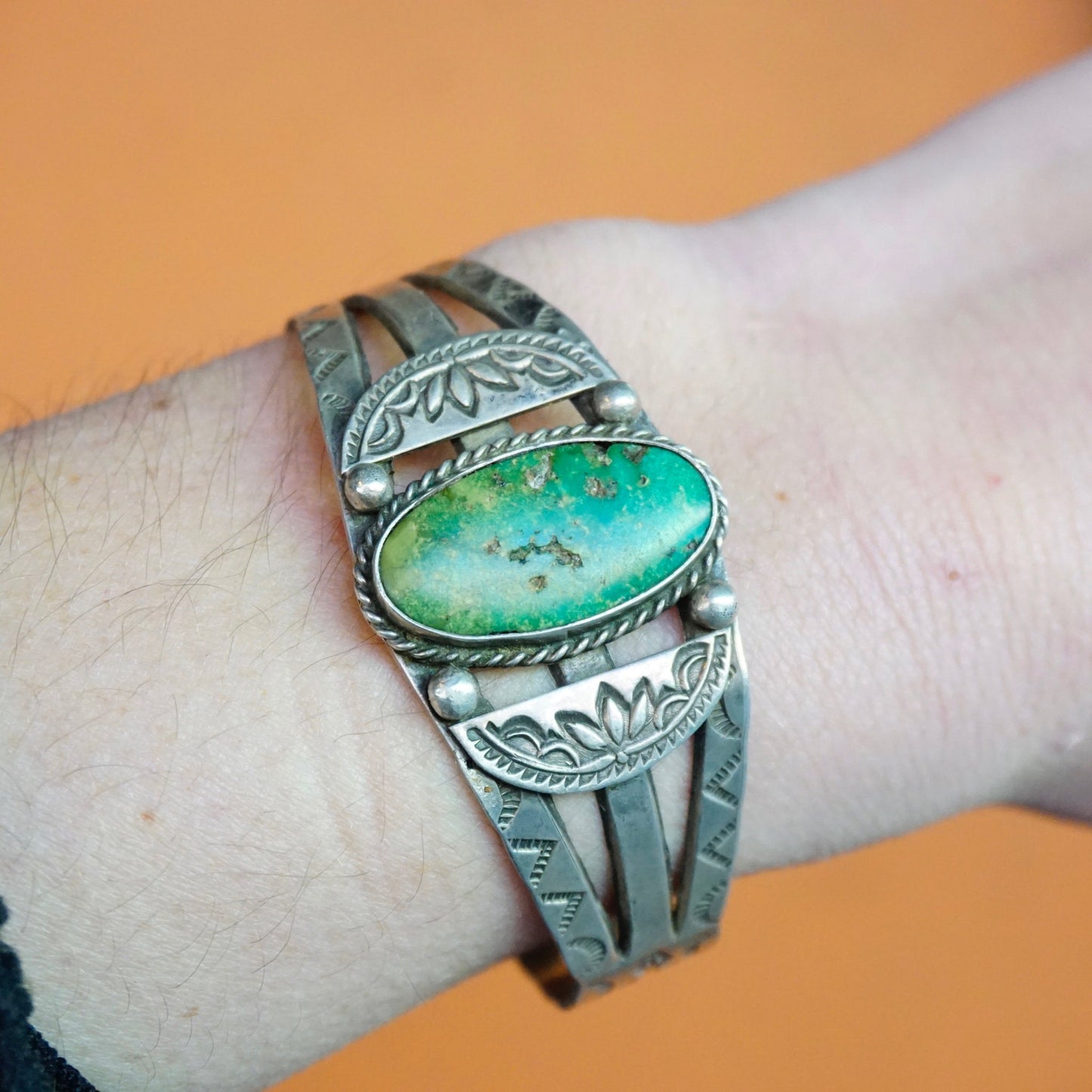 Vintage Native American silver cuff bracelet with intricate engraved design and natural turquoise stone, handcrafted old pawn jewelry