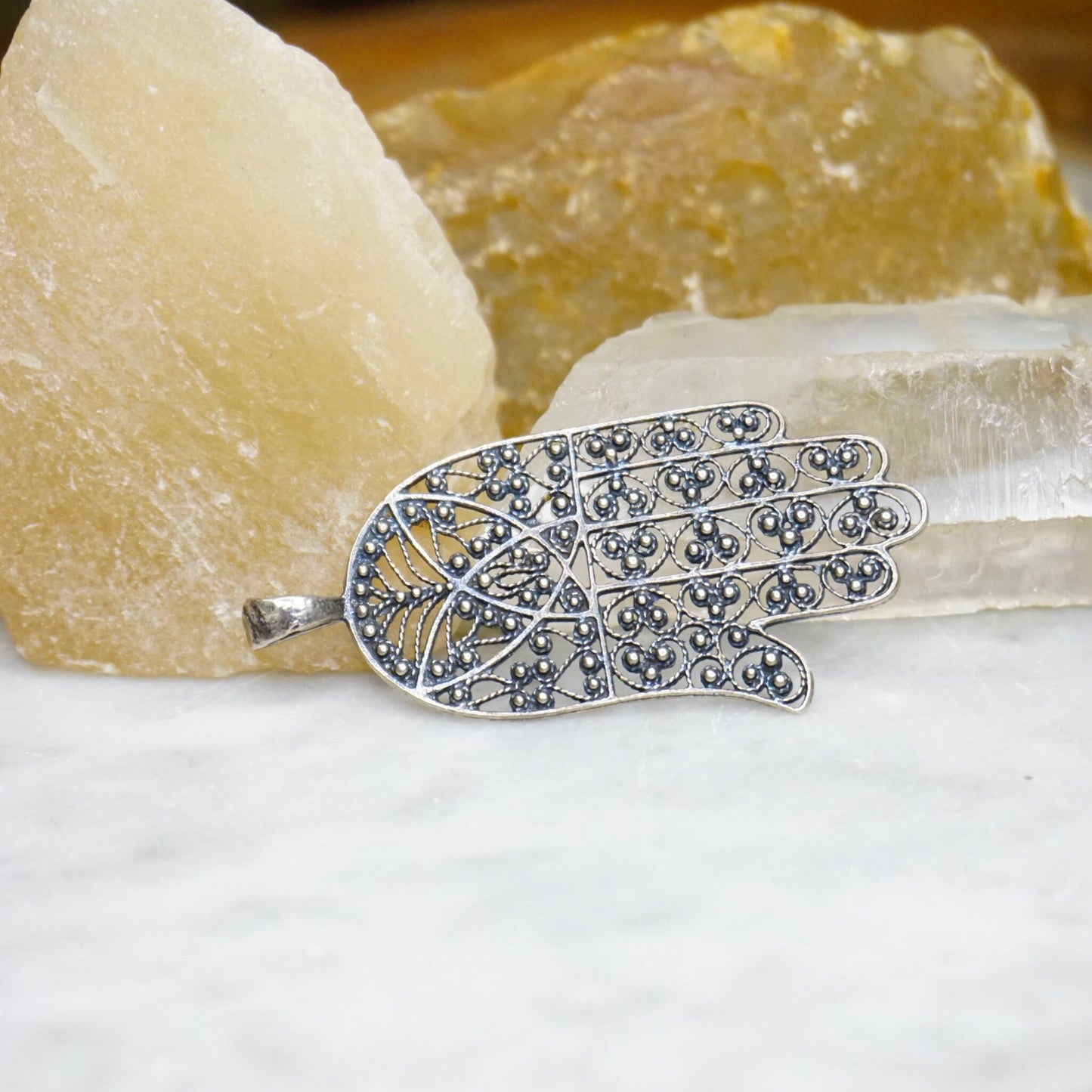 Vintage sterling silver filigree Hamsa hand pendant with intricate detailing, made in Israel. Hamsa hand is a protective talisman in 925 silver jewelry.