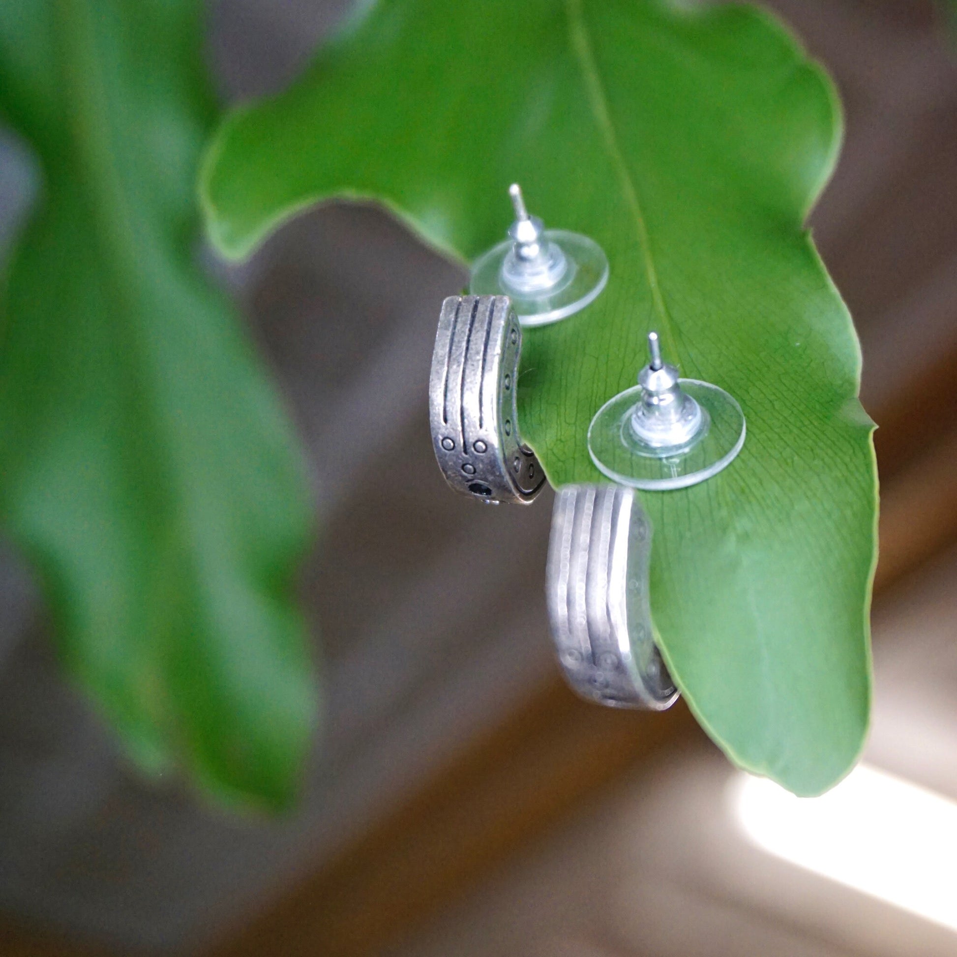 Silver hoop earrings with black and white crystals on a green leaf, modernist style vintage earrings by Patricia Locke