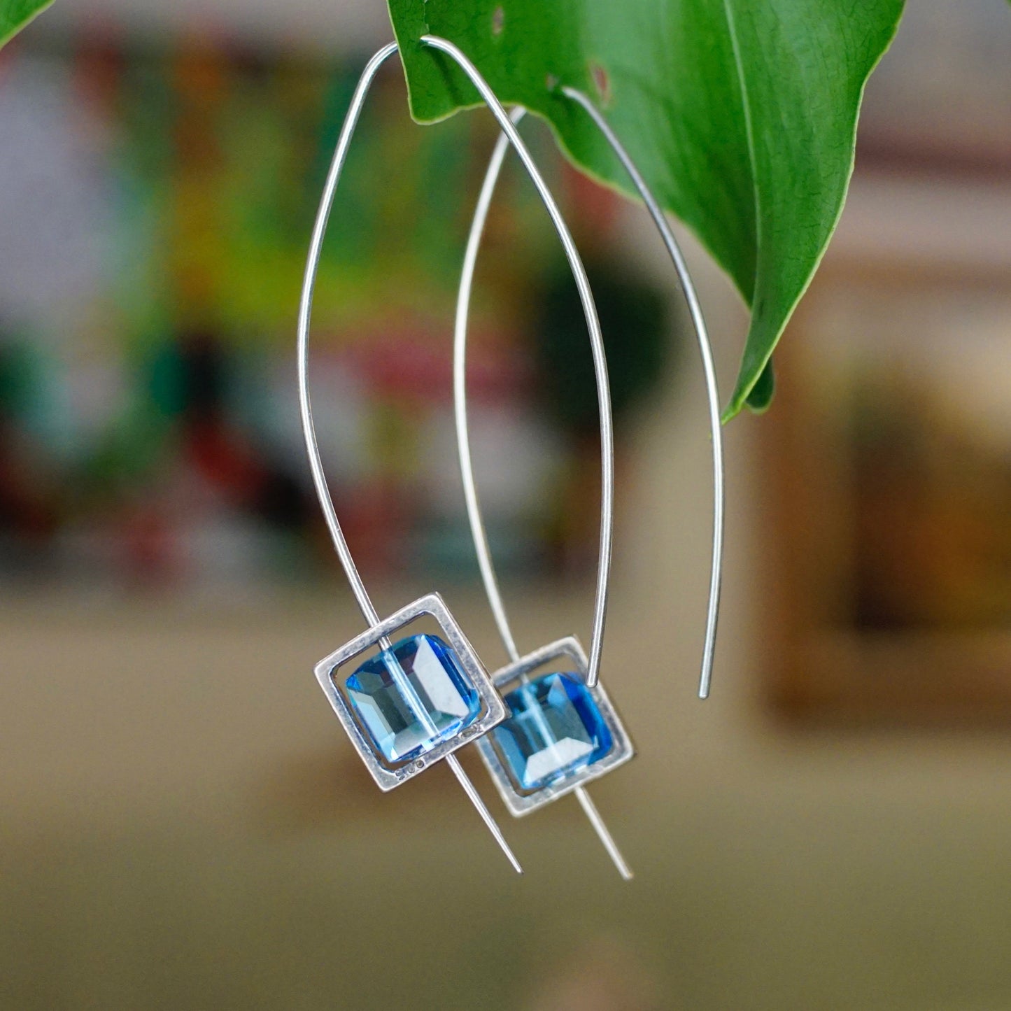 Vintage sterling silver marquise hook earrings with framed blue glass, hanging from green leaf, minimalist 925 silver and glass dangle earrings