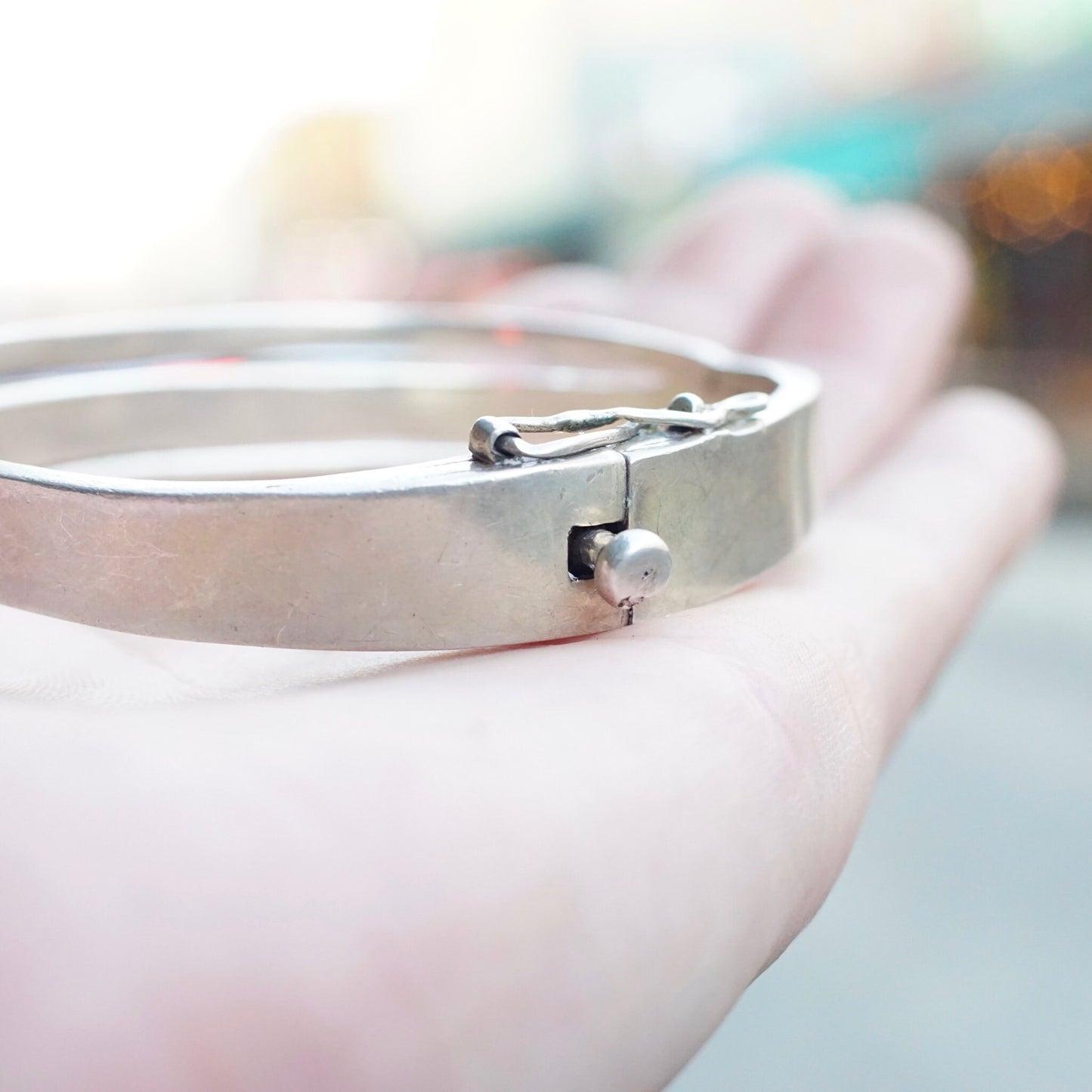 Vintage sterling silver hinged bangle bracelet with modernist cut out design from Taxco, Mexico. 925 silver, 6 1/2 inches long.