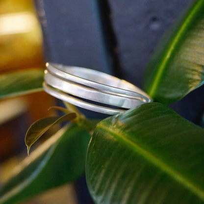 Vintage sterling silver hinged bangle bracelet with modernist cut out design from Taxco, Mexico, measuring 6 1/2 inches long.