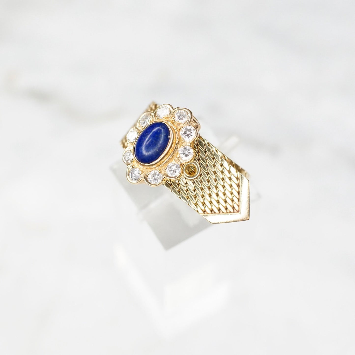 Vintage 14K yellow gold adjustable mesh belt buckle ring featuring a lapis lazuli cabochon surrounded by diamond accents, signed VCA NY 14K.