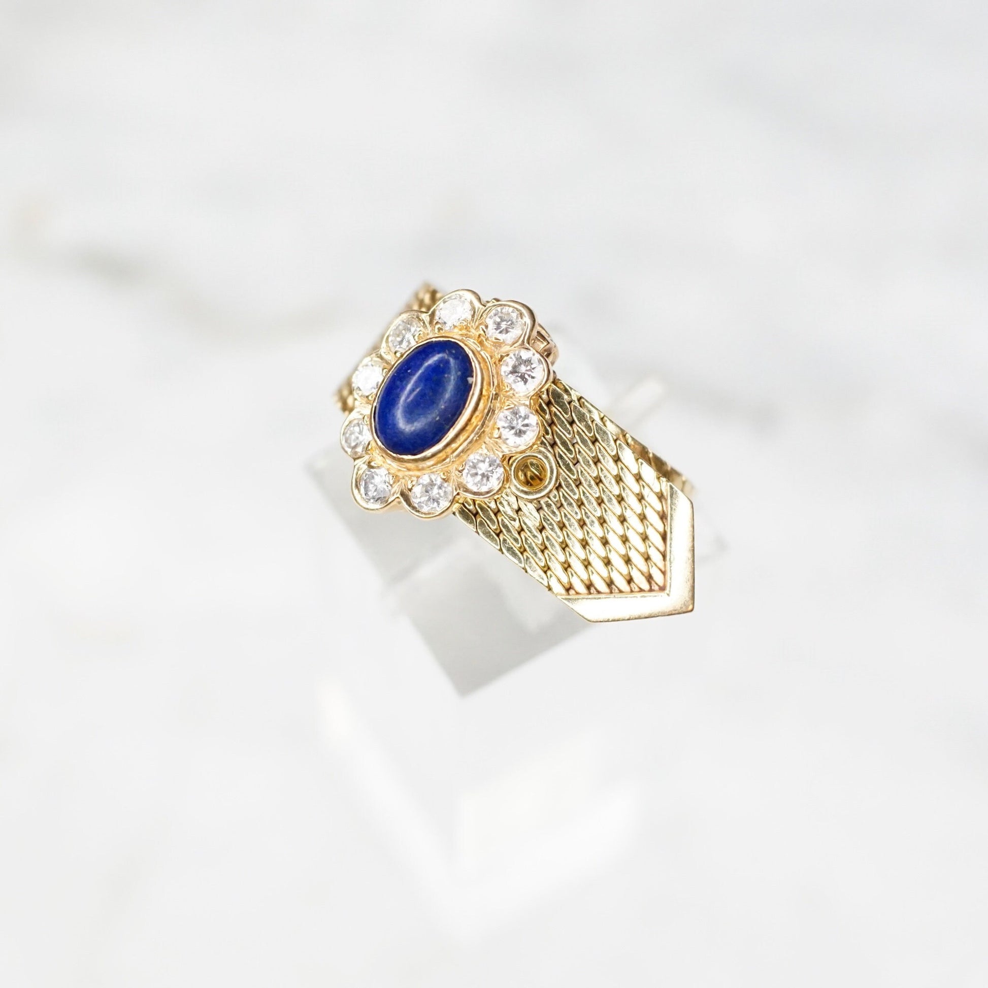 Vintage 14K yellow gold adjustable mesh belt buckle ring featuring a lapis lazuli cabochon surrounded by diamond accents, signed VCA NY 14K.