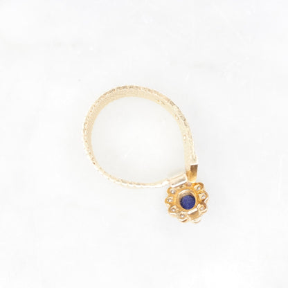 Vintage 14K yellow gold mesh belt buckle ring featuring a lapis lazuli cabochon surrounded by small diamonds set in a flower design. The ring band is an adjustable mesh style. Stamped VCA NY 14K.