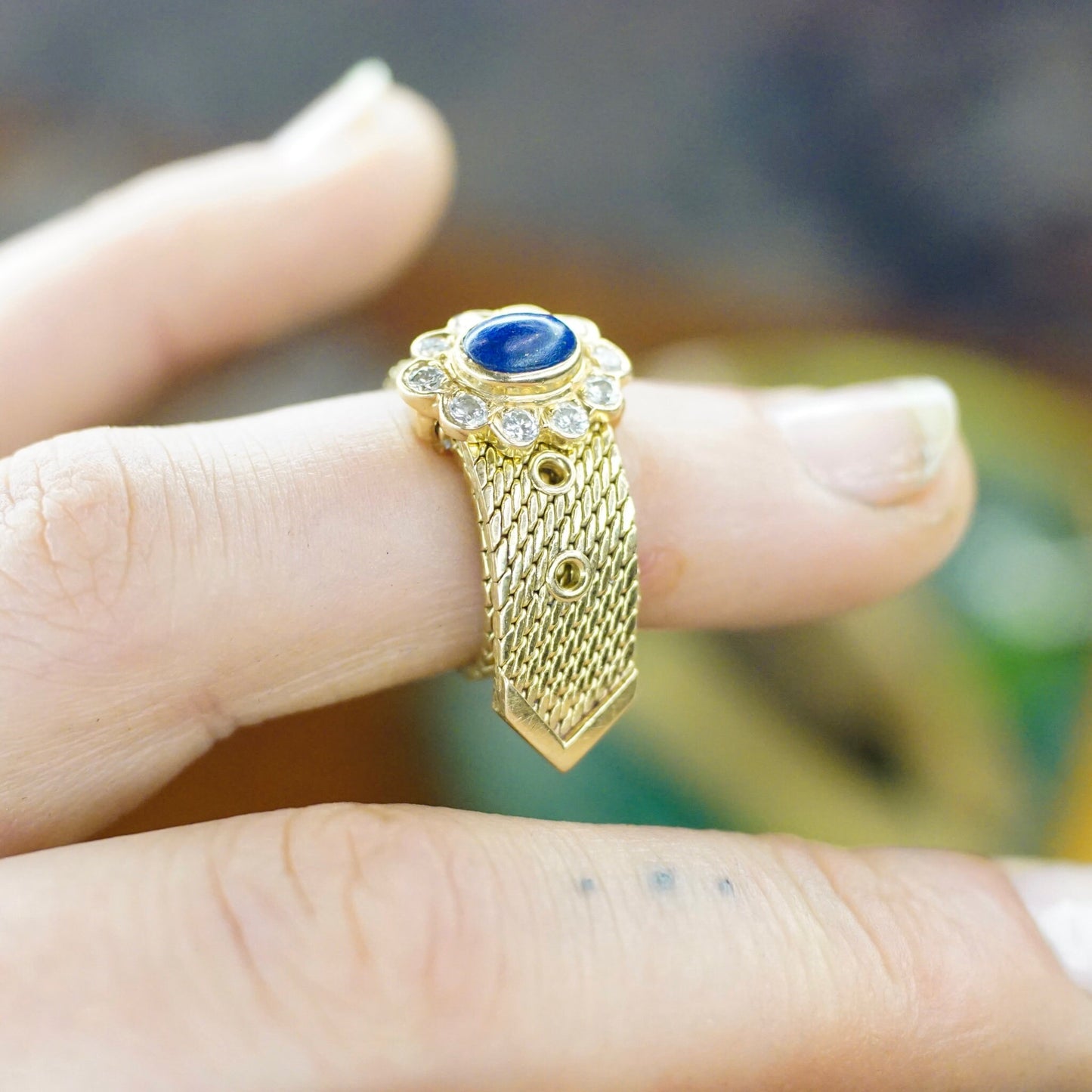 Vintage 14K yellow gold mesh belt buckle ring with lapis lazuli and diamond flower design, adjustable band size, stamped VCA NY 14K, shown on finger