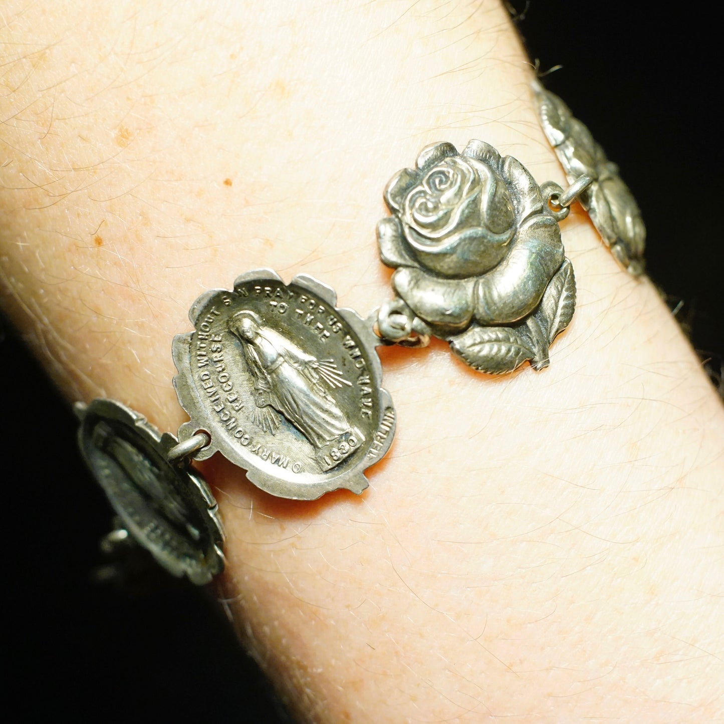 Vintage HMH sterling silver reversible bracelet featuring a rosebud charm on one side and Virgin Mary patron saint charm on the other, religious 925 silver link bracelet jewelry.