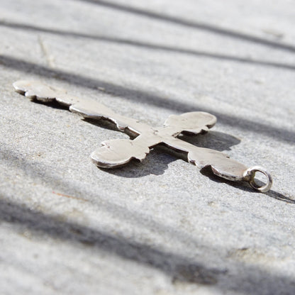 Vintage large sterling silver gothic cross pendant on textured concrete surface, oxidized hammered 925 silver, approximately 4 inches long, ornate design