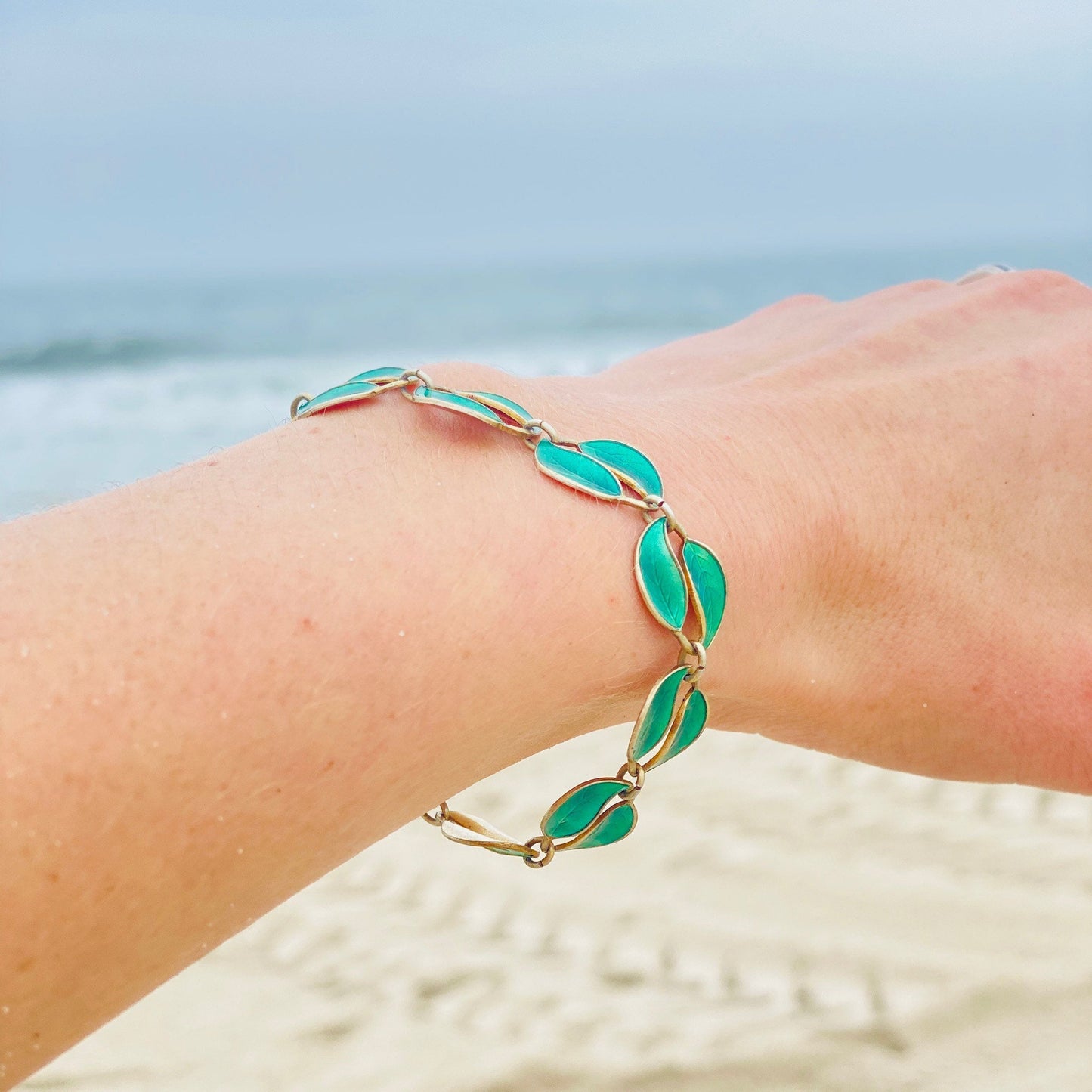 Vintage David Andersen Norway sterling silver guilloche enamel leaf link bracelet on wrist at the beach