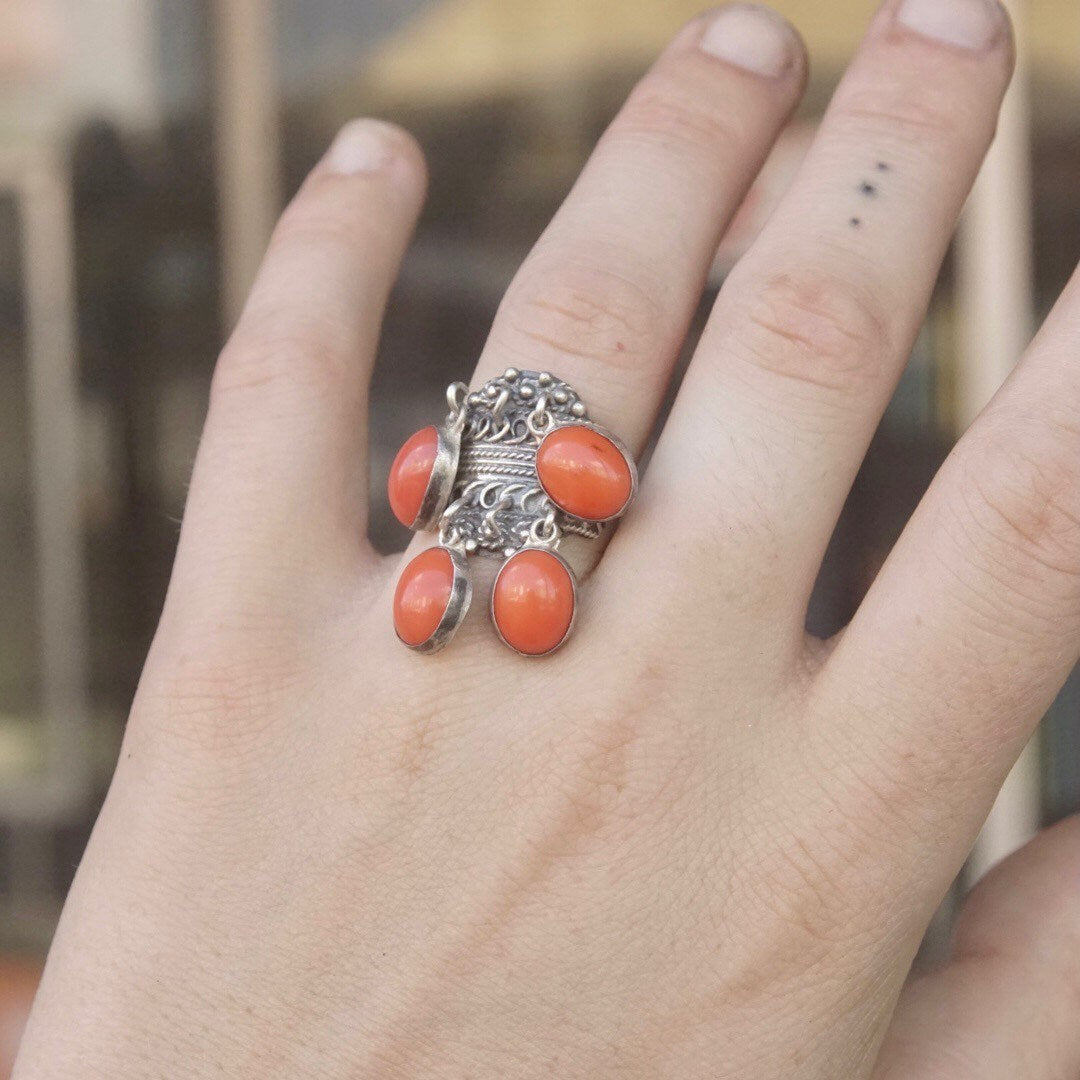 Vintage TAXCO sterling silver filigree ring with hanging red/orange coral beads on a hand, adjustable size, made in Mexico 925 silver.