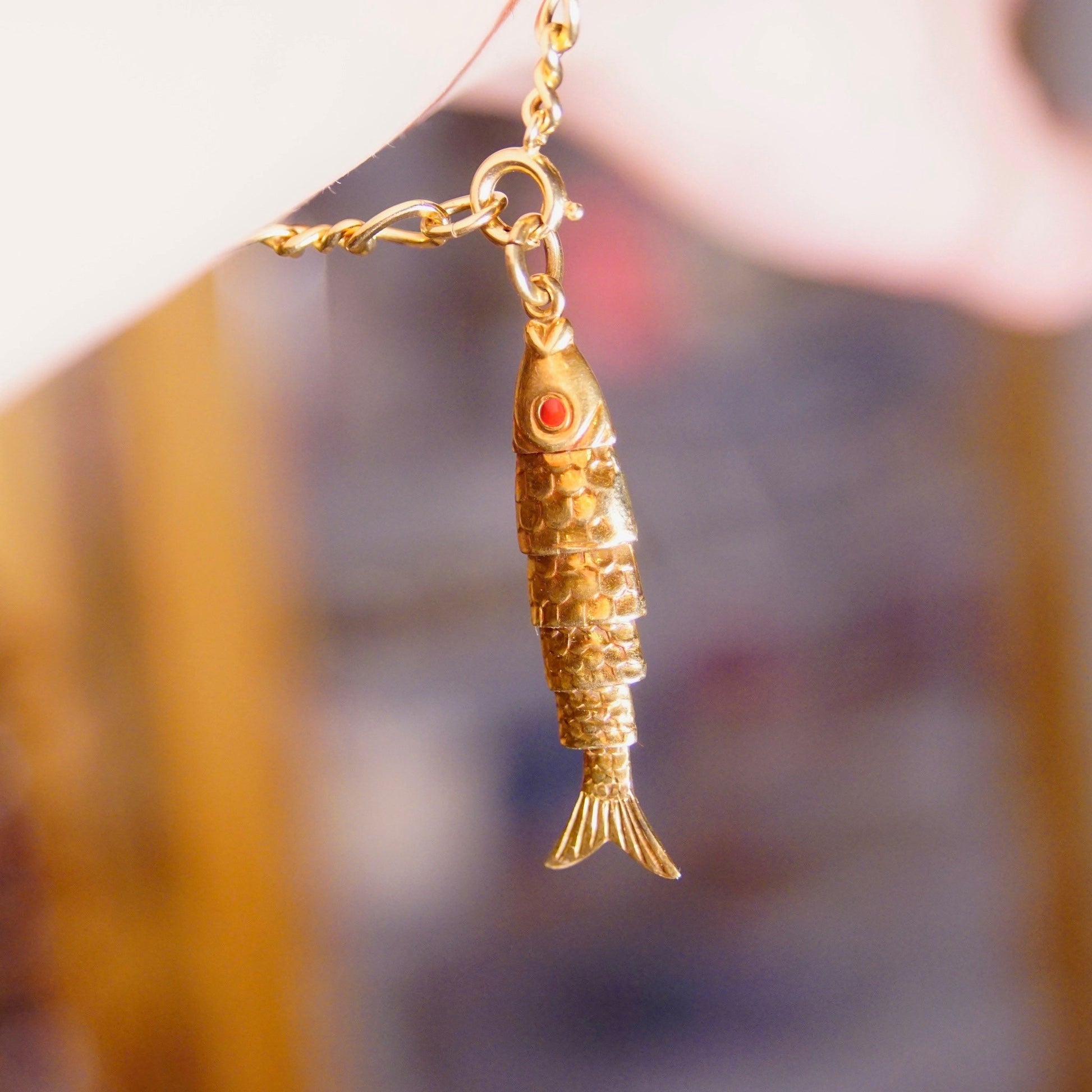 18K yellow gold articulated fish pendant charm with red cabochon eyes and movable scaled body, vintage 750 gold fish charm measures 2 inches long