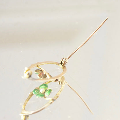 Vintage 10K gold brooch pin featuring a green enamel four-leaf clover design accented with a tiny seed pearl, measuring 1 1/8 inches long, in the Art Nouveau style.