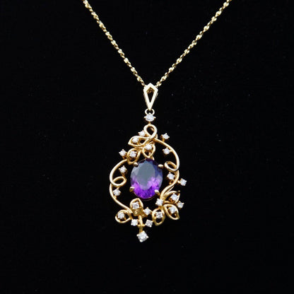 Vintage 14K gold amethyst and diamond pendant choker necklace featuring an oval faceted amethyst stone framed by an ornate diamond-studded gold setting, suspended from a delicate 14 3/4 inch long chain.