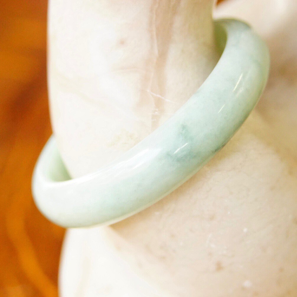 Vintage mid-century solid light green marbled jade bangle bracelet, 54 grams, 7 inches long.