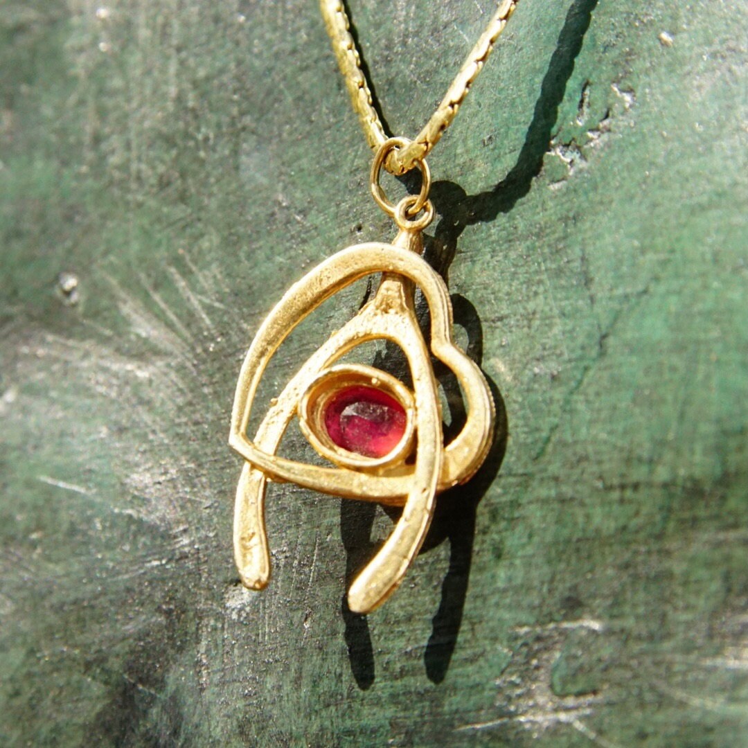 Vintage 14K yellow gold wishbone heart pendant necklace with faceted red ruby on a thin 2mm flat gold chain, 20.5 inches long.