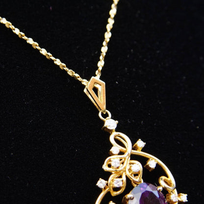 Vintage 14K gold amethyst and diamond pendant choker necklace with faceted amethyst stone set in an ornate diamond-studded gold frame on a delicate 14 3/4 inch chain.