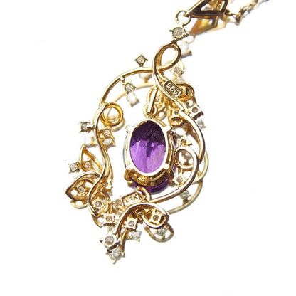 Vintage 14K gold amethyst and diamond pendant choker necklace featuring a faceted amethyst stone set in an ornate diamond-studded gold frame, measuring 14 3/4 inches long.