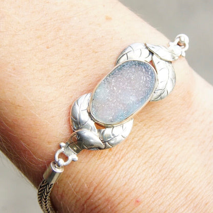 Vintage sterling silver leaf design bracelet with translucent light blue textured druzy quartz gemstone, 7 to 8 inches long, on rope chain against skin