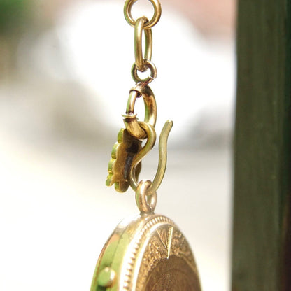 Victorian gold filled locket pendant mourning necklace with garnet or diamond, featuring an etched cameo design on a thick gold chain.