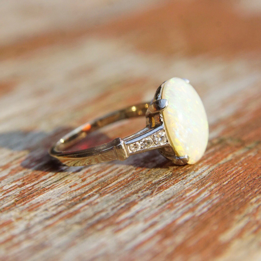 Vintage 14K white gold opal ring with iridescent white opal stone and diamond accents in a cathedral setting, size 5 1/2 US.