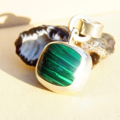 Vintage Taxco sterling silver pendant with banded malachite stone, featuring a modernist design and double loop necklace bail, crafted in Mexico from 925 silver.