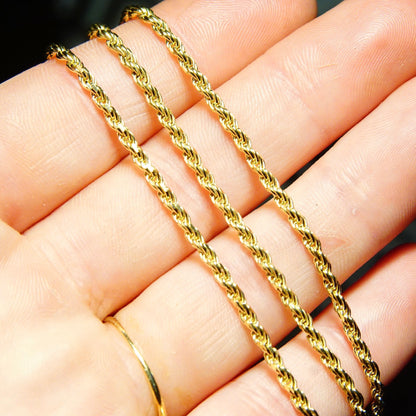 Vintage 14K yellow gold rope chain necklace, 2.5mm thick, shown against fingers to demonstrate scale, 24 inches long, suitable for pendants, unisex jewelry.