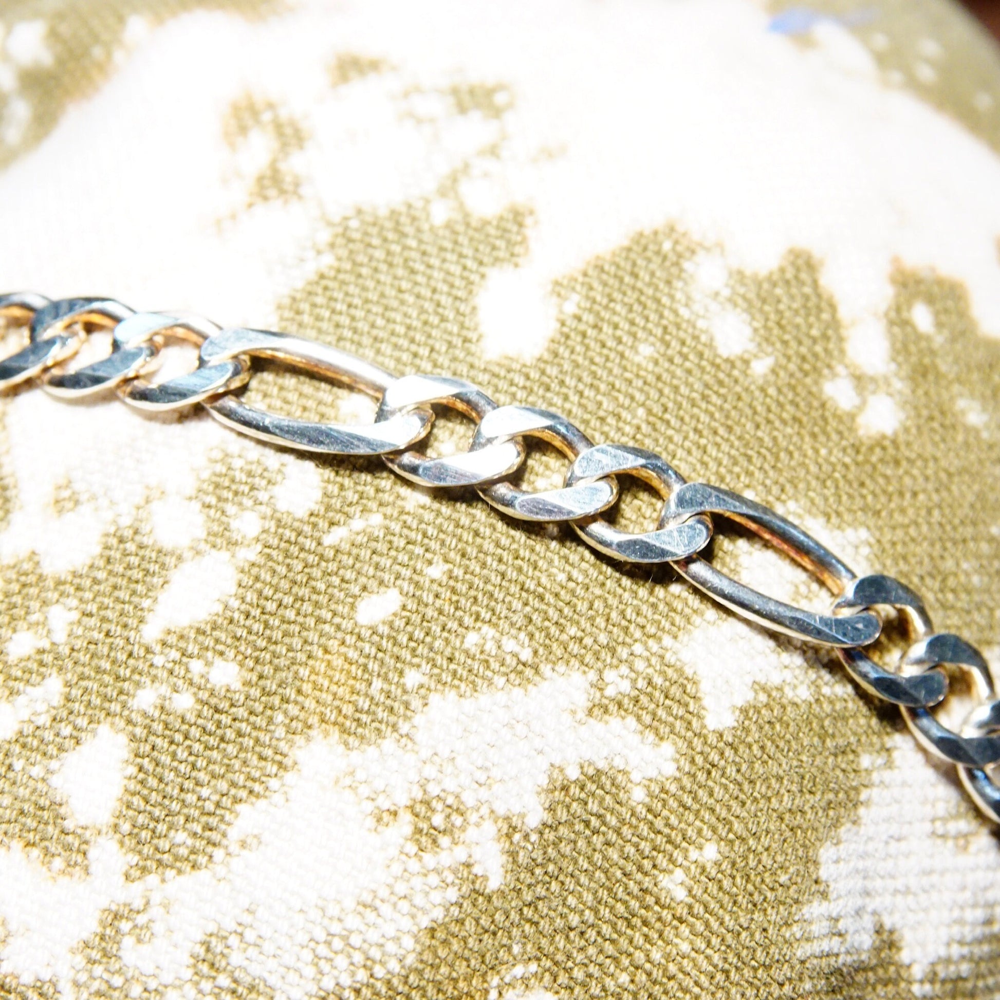 Vintage Italian sterling silver and gold panther figaro chain bracelet with heavy 7mm silver links and gold accent panther clasp, measuring 8 1/4 inches long.