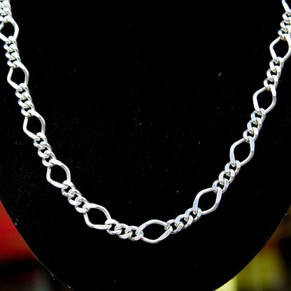 Vintage Milor 925 sterling silver figaro chain necklace with alternating 5mm curb links and 8.5mm long links, measuring 24 1/4 inches long, displayed on black velvet background