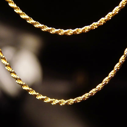 14K yellow gold rope chain necklace, 2.5mm width, 24 inches long, on black background