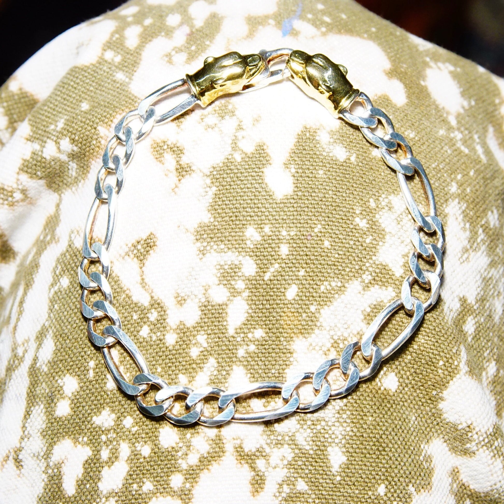 Vintage Italian sterling silver and gold panther figaro chain bracelet with heavy 7mm silver chain and accent gold panther clasp, measuring 8 1/4 inches long.