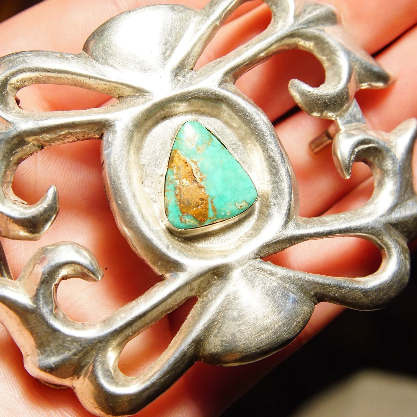 Vintage Native American sterling silver sand cast belt buckle featuring natural turquoise stone, signed "Phillip", measuring 3 1/8 inches wide, showcasing intricate craftsmanship and artisan design.