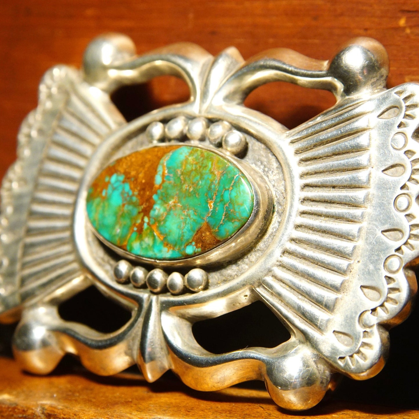 Vintage Native American silver and turquoise belt buckle handcrafted by renowned Zuni artist Art Acoya, featuring intricate sandcast metalwork and a vibrant natural turquoise stone set in an ornate silver frame with scrollwork details, measuring 2 7/8 inches wide, old pawn Southwest jewelry.