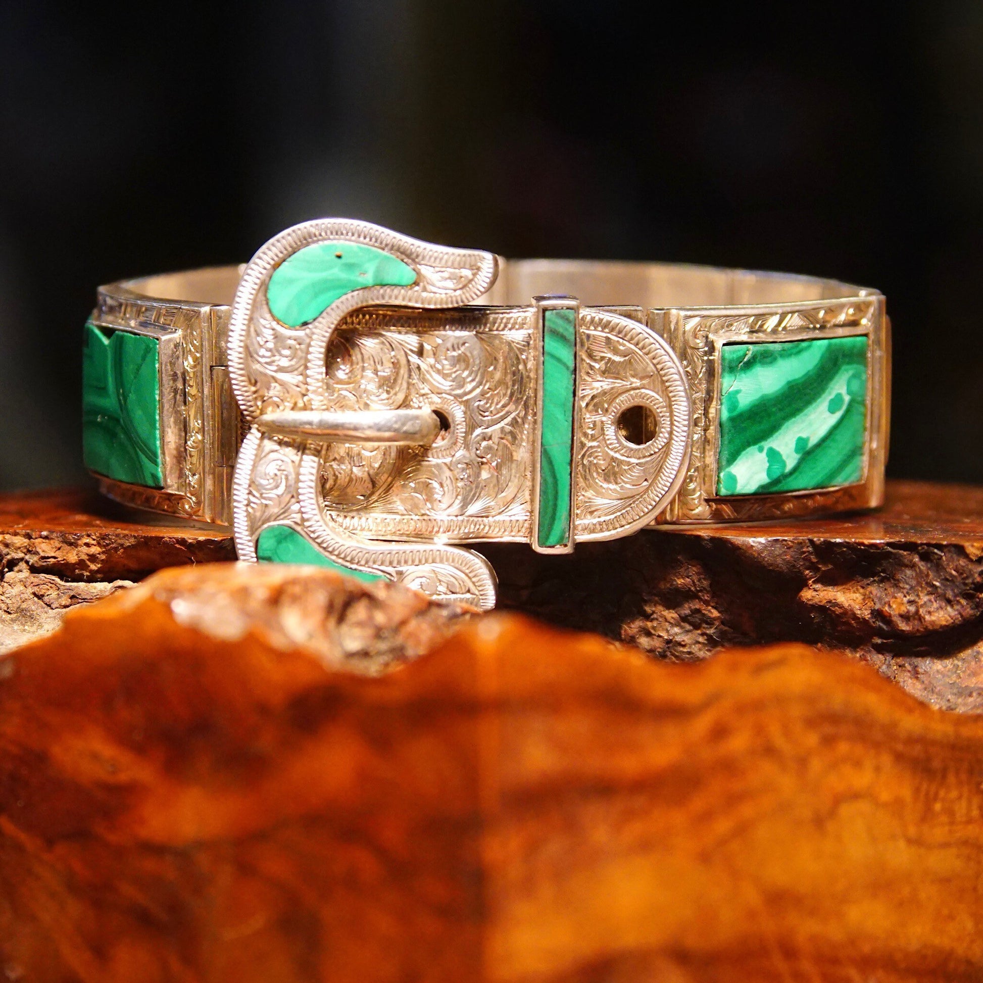 Antique Victorian silver bracelet with ornate etched designs and malachite inlays, featuring a Scottish belt buckle style clasp. The bracelet measures 7 1/8 inches long.