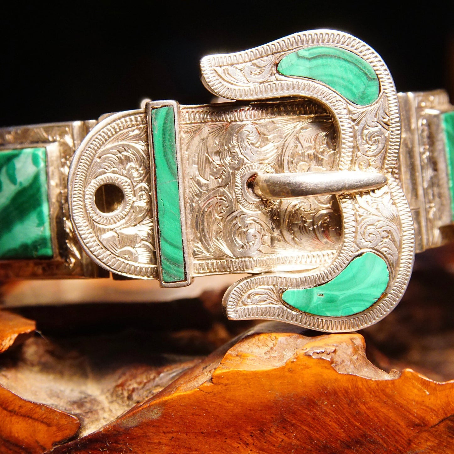 Antique Victorian silver bracelet with malachite inlay featuring ornate etched designs and a belt buckle style clasp, measuring 7 1/8 inches long.