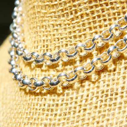 Vintage sterling silver rolo chain with 1/4 inch interlocking bead links, heavy silver chain necklace, unisex jewelry, 23 3/4 inches long, close-up detail of textured woven silver chain on burlap fabric background