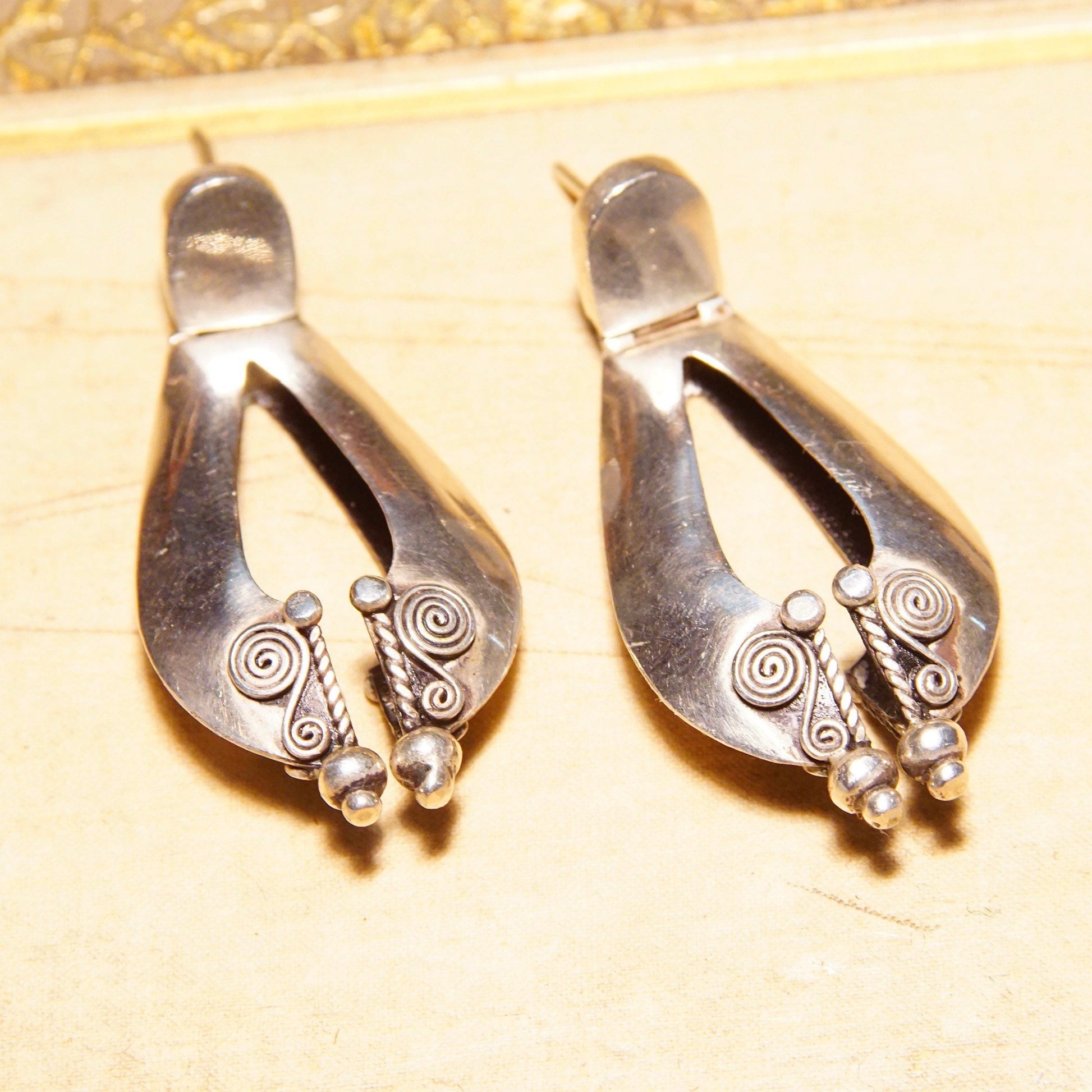 Vintage sterling silver pierced dangle earrings featuring puffed teardrop design with wire wrap accents, measuring 1 7/8 inches long, in Bali style for bohemian accessories.