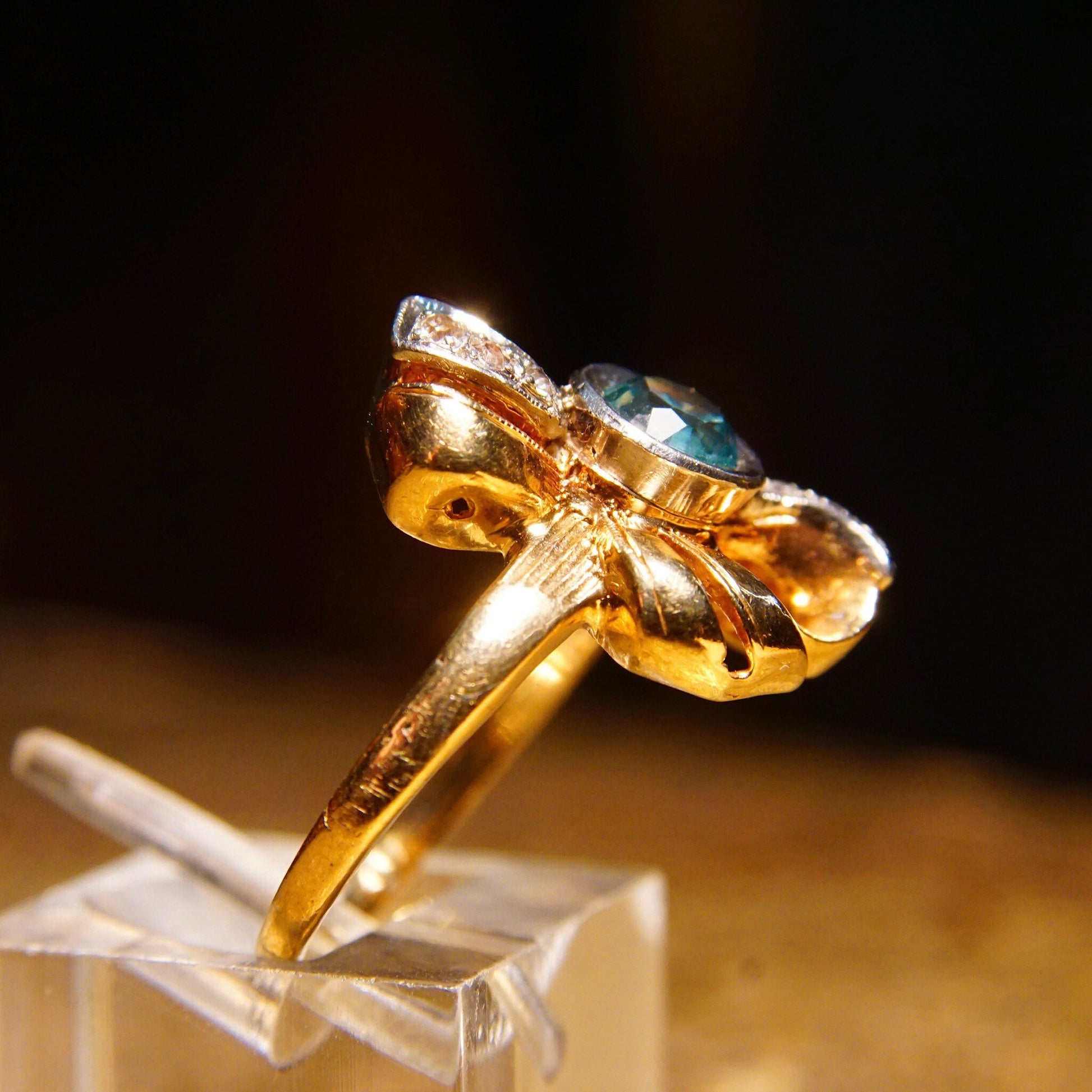 Antique 10K gold blue topaz and diamond bow ring with ribbon setting and white gold accents, size 6 3/4 US, by JR Woods & Sons.